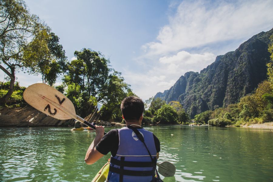 Laos Vang Vieng asian man kayaking
