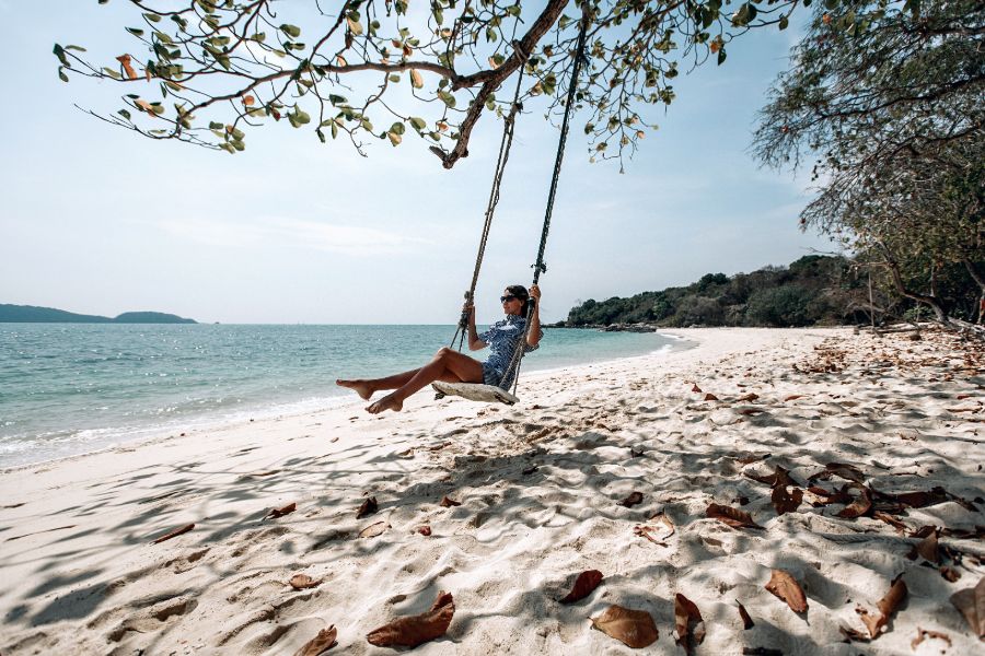 Thailand Phuket tourist summerholiday happy traveler female sunglasses relaxing on swing